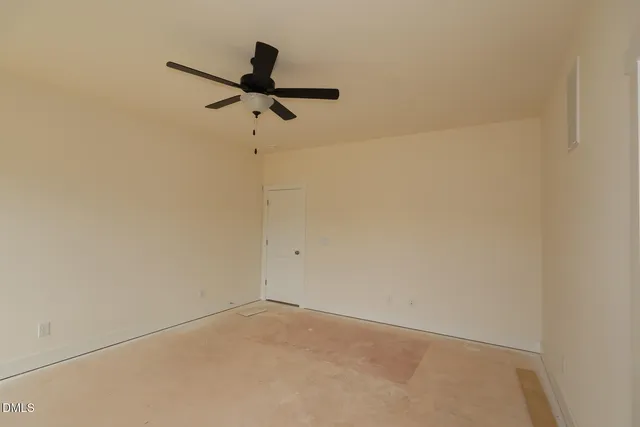 a view of a room with a ceiling fan