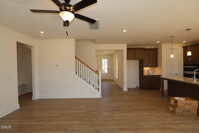 a view of a hallway with a dining table chairs