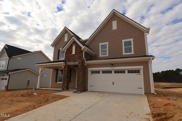 a front view of a house with a garage