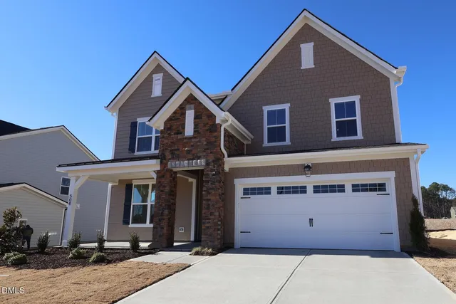 a front view of a house with yard