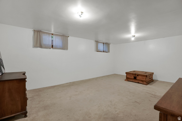 6 Terrace Place Logan, UT 84321 - Photo 25 of 26 Spacious room with white walls, two windows, recessed lighting, and carpeting throughout