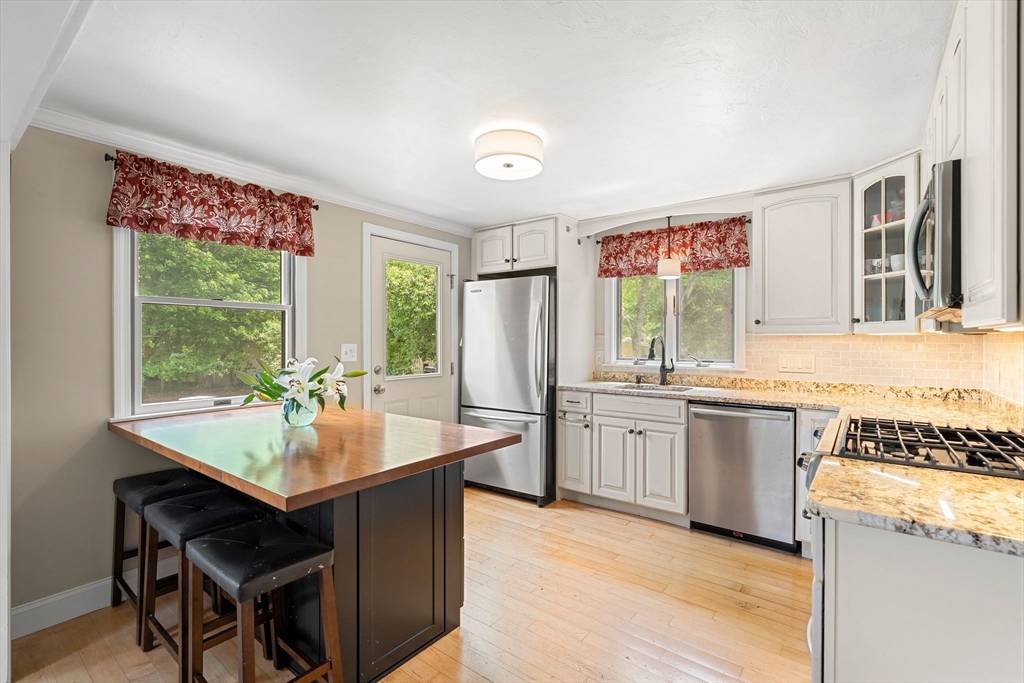 35 Spallus Road Stoughton, MA 02072 - Photo 17 of 39 a kitchen with a stove a sink and a refrigerator