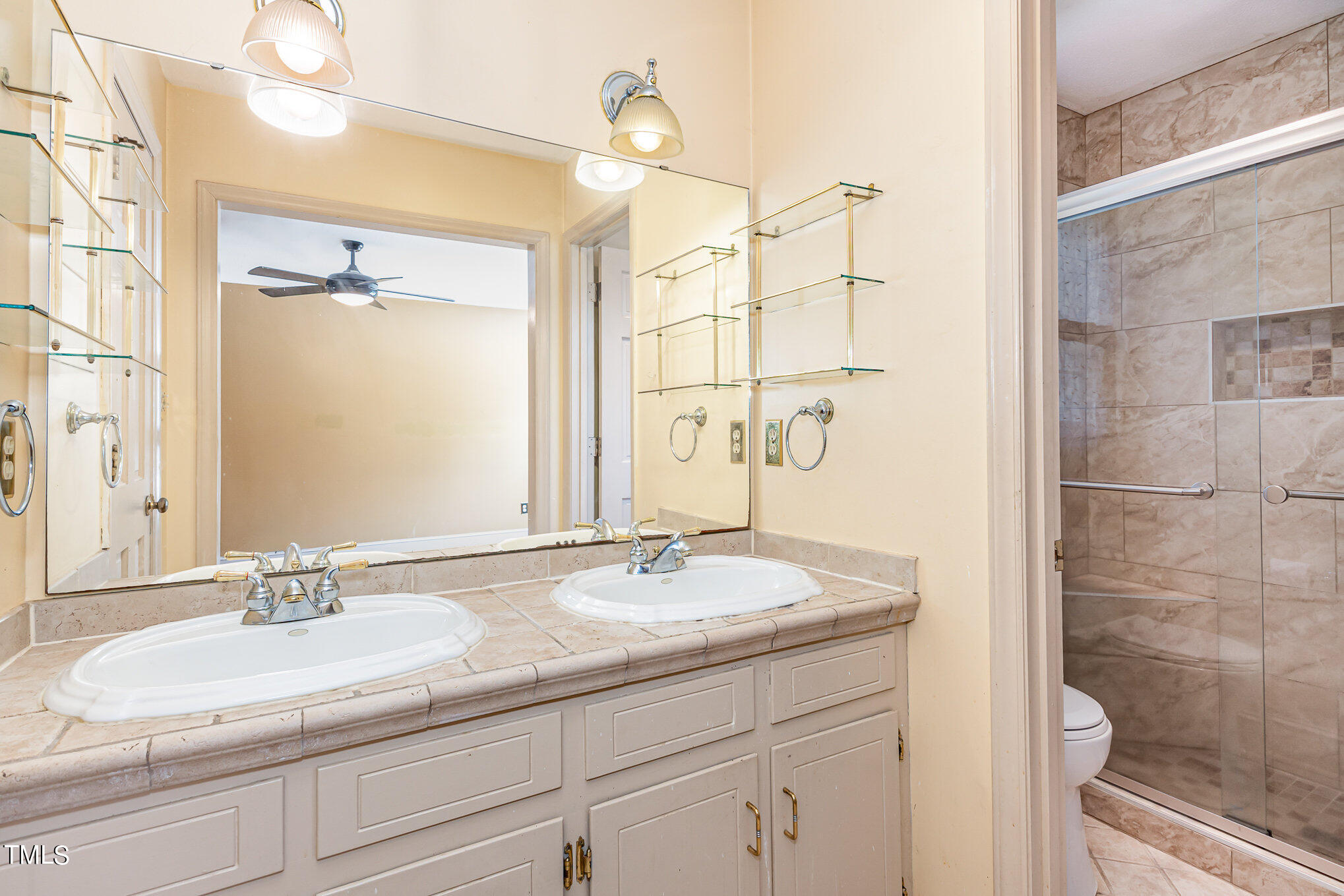 1921 Carthage Circle Raleigh, NC 27604 - Photo 11 of 19 a bathroom with a granite countertop sink a mirror and a shower