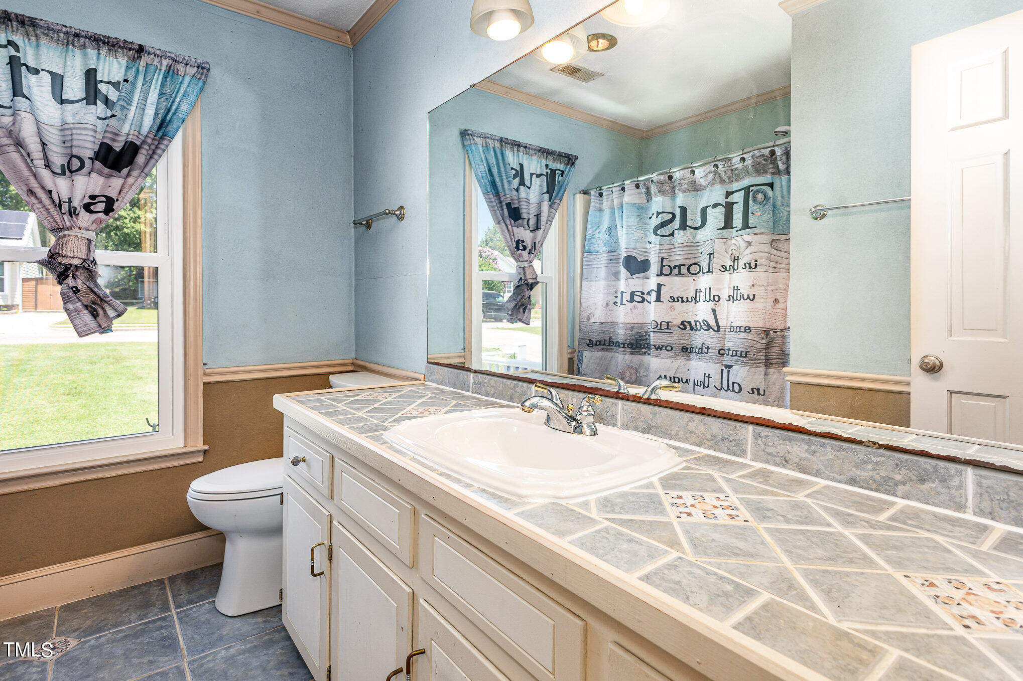 1921 Carthage Circle Raleigh, NC 27604 - Photo 13 of 19 a bathroom with a sink toilet mirror and shower