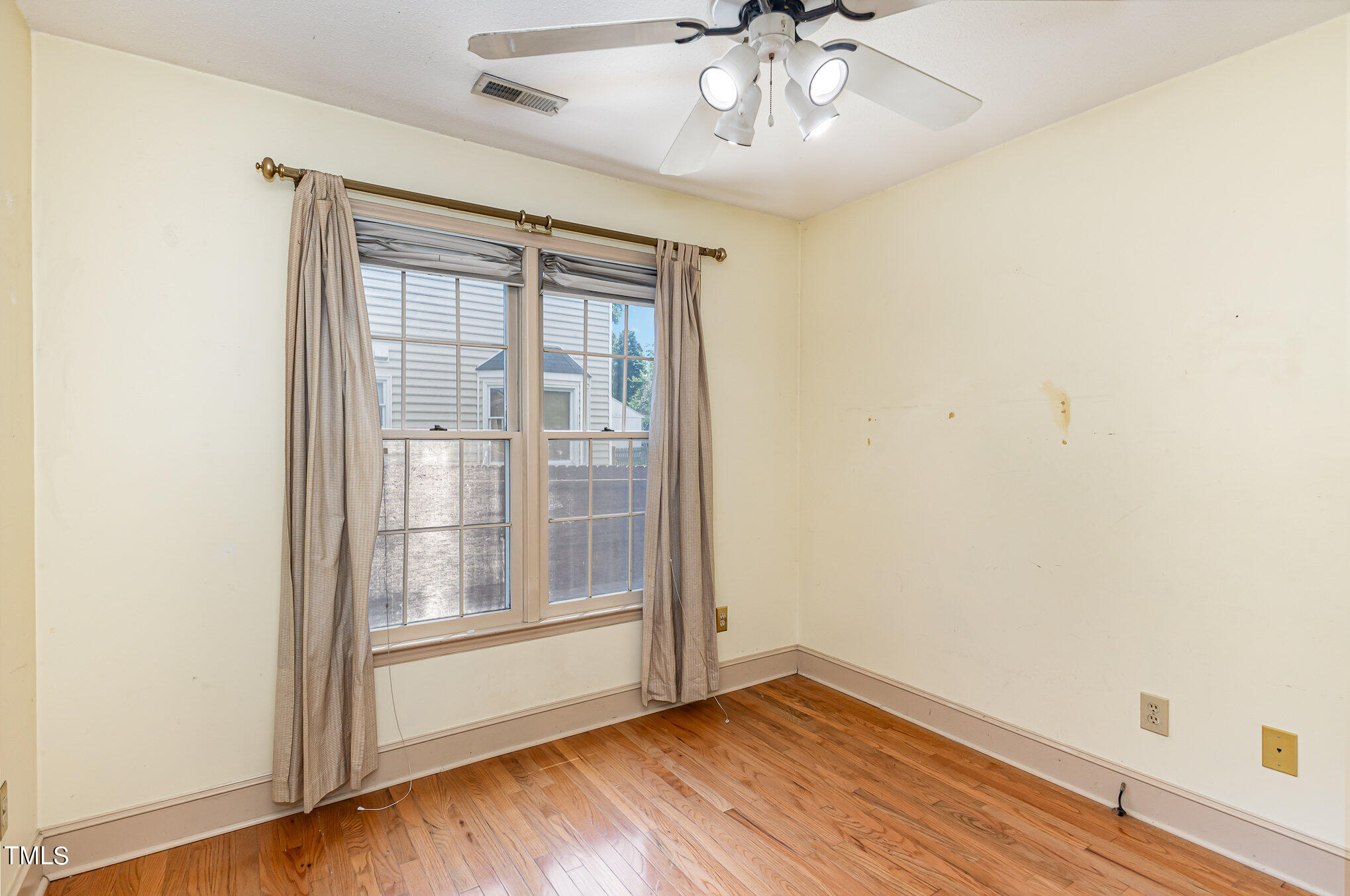 1921 Carthage Circle Raleigh, NC 27604 - Photo 14 of 19 an empty room with wooden floor fan and windows