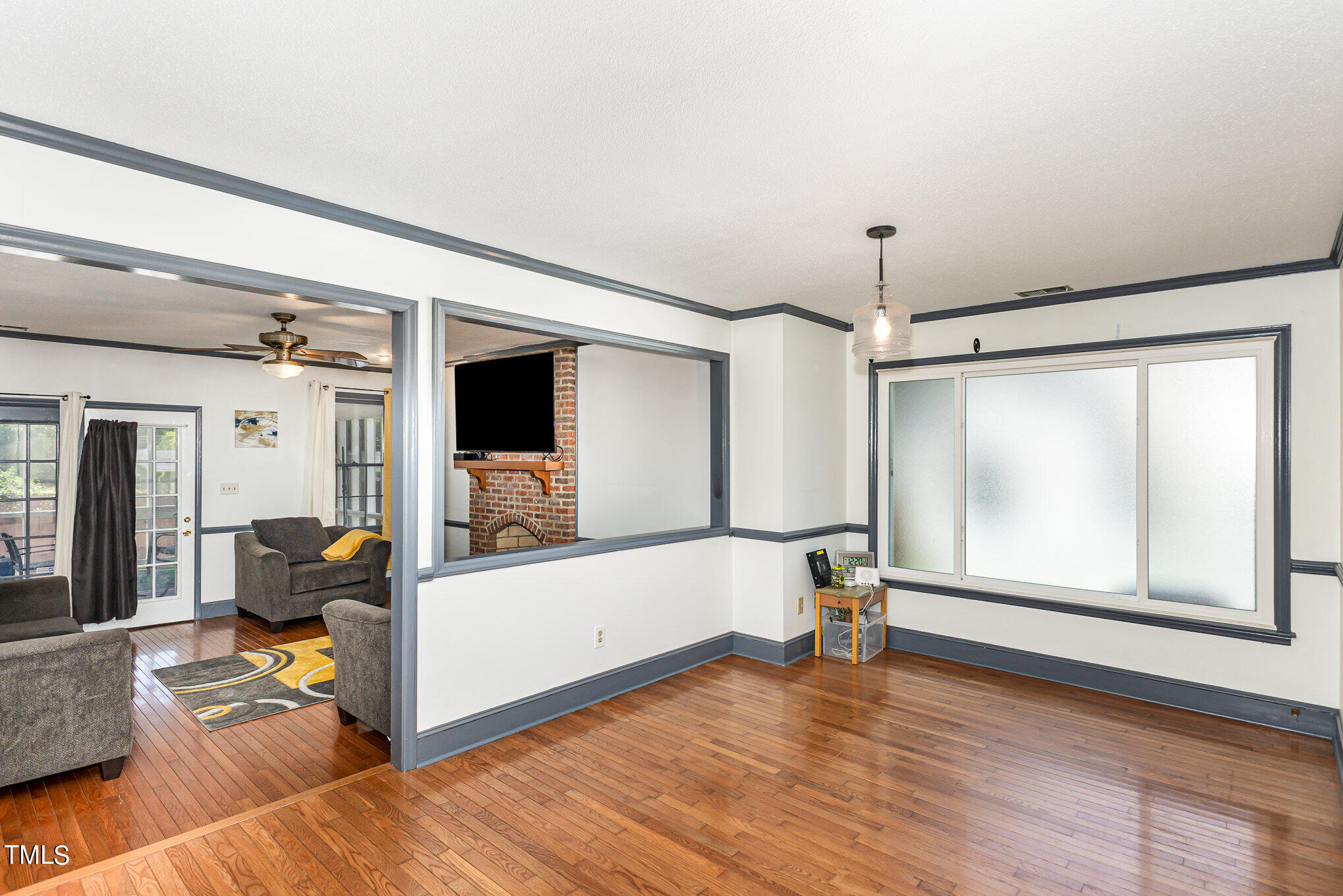 1921 Carthage Circle Raleigh, NC 27604 - Photo 4 of 19 a view of empty room with wooden floor and fan