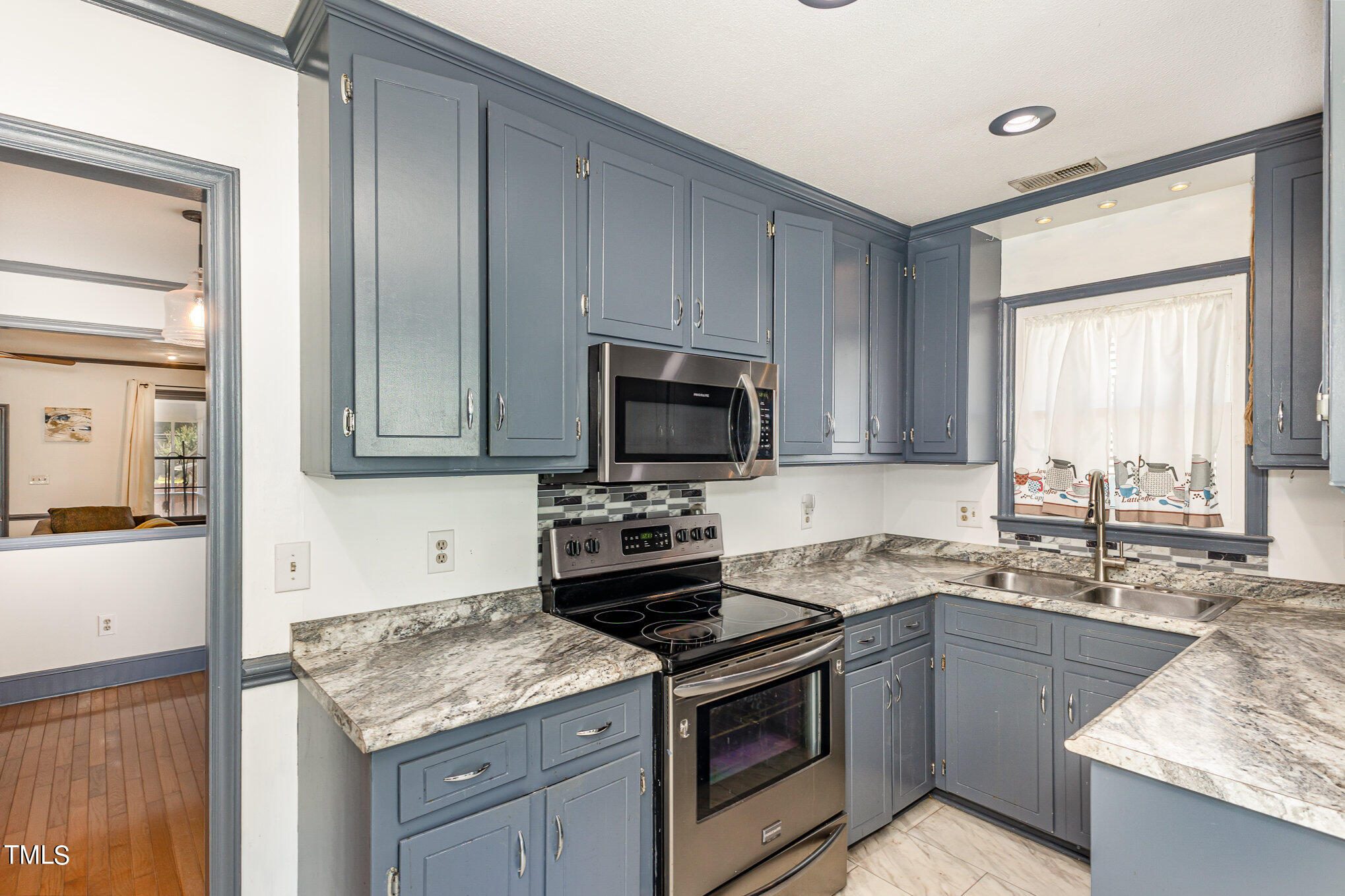 1921 Carthage Circle Raleigh, NC 27604 - Photo 5 of 19 a kitchen with a sink stove and microwave