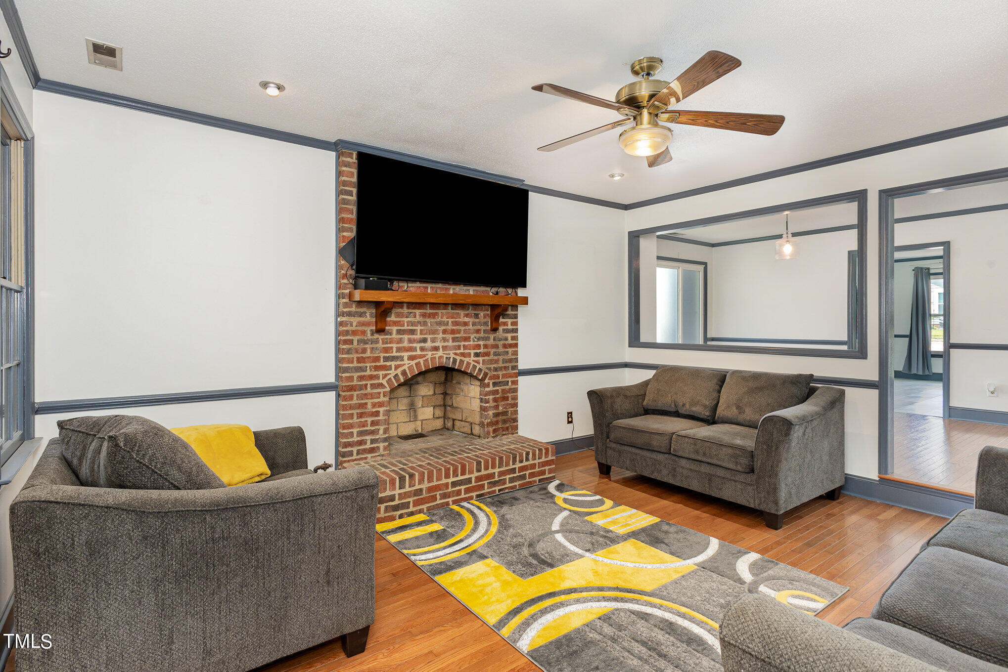 1921 Carthage Circle Raleigh, NC 27604 - Photo 8 of 19 a living room with furniture ceiling fan and a flat screen tv