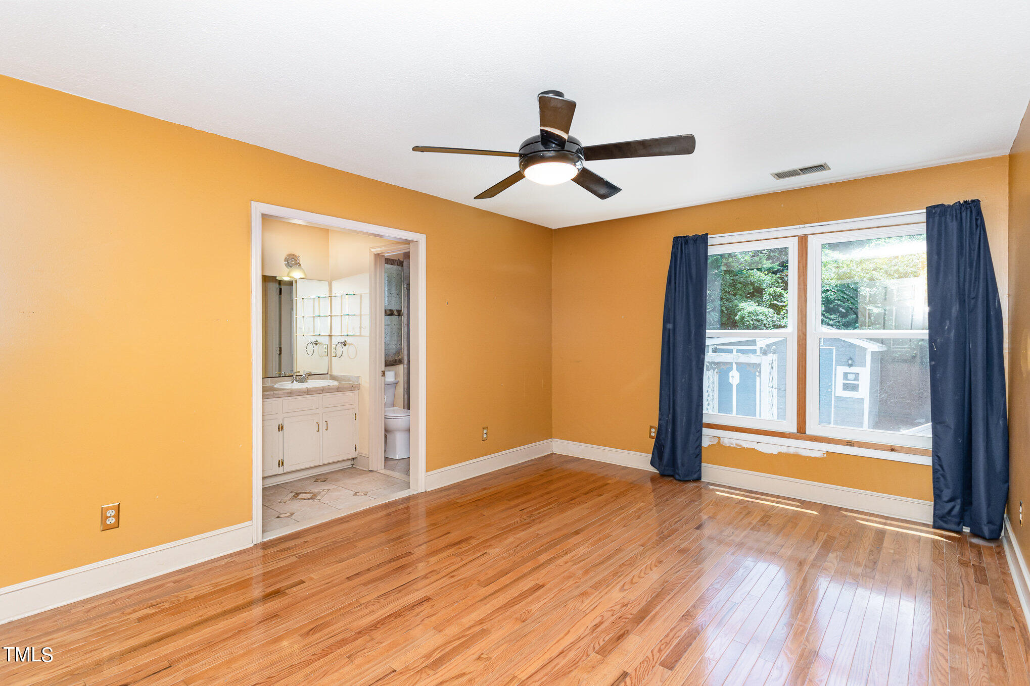 1921 Carthage Circle Raleigh, NC 27604 - Photo 9 of 19 a view of empty room with wooden floor and fan