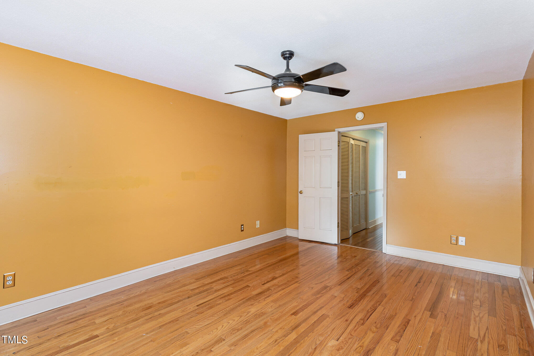 1921 Carthage Circle Raleigh, NC 27604 - Photo 10 of 19 a view of an empty room with wooden floor and a ceiling fan