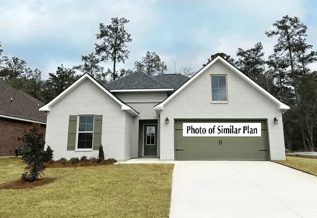 a view of a house with a yard and potted plants