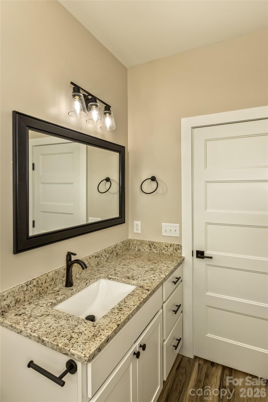 112 Peyton Elaine Road Clyde, NC 28721 - Photo 22 of 35 a bathroom with a granite countertop sink and a mirror