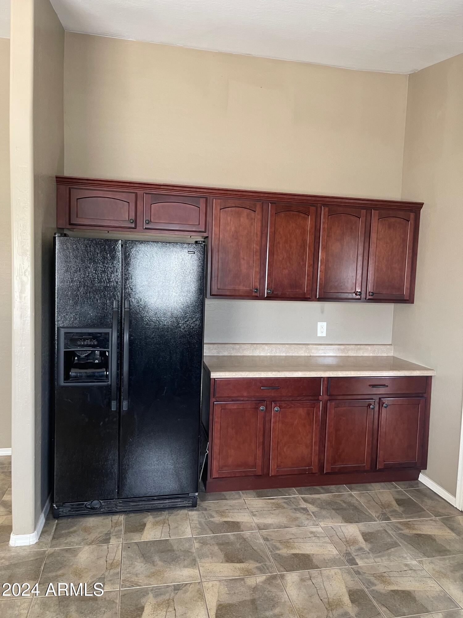 115 West 10th Street Casa Grande, AZ 85122 - Photo 3 of 14 a view of a refrigerator in kitchen and an empty room