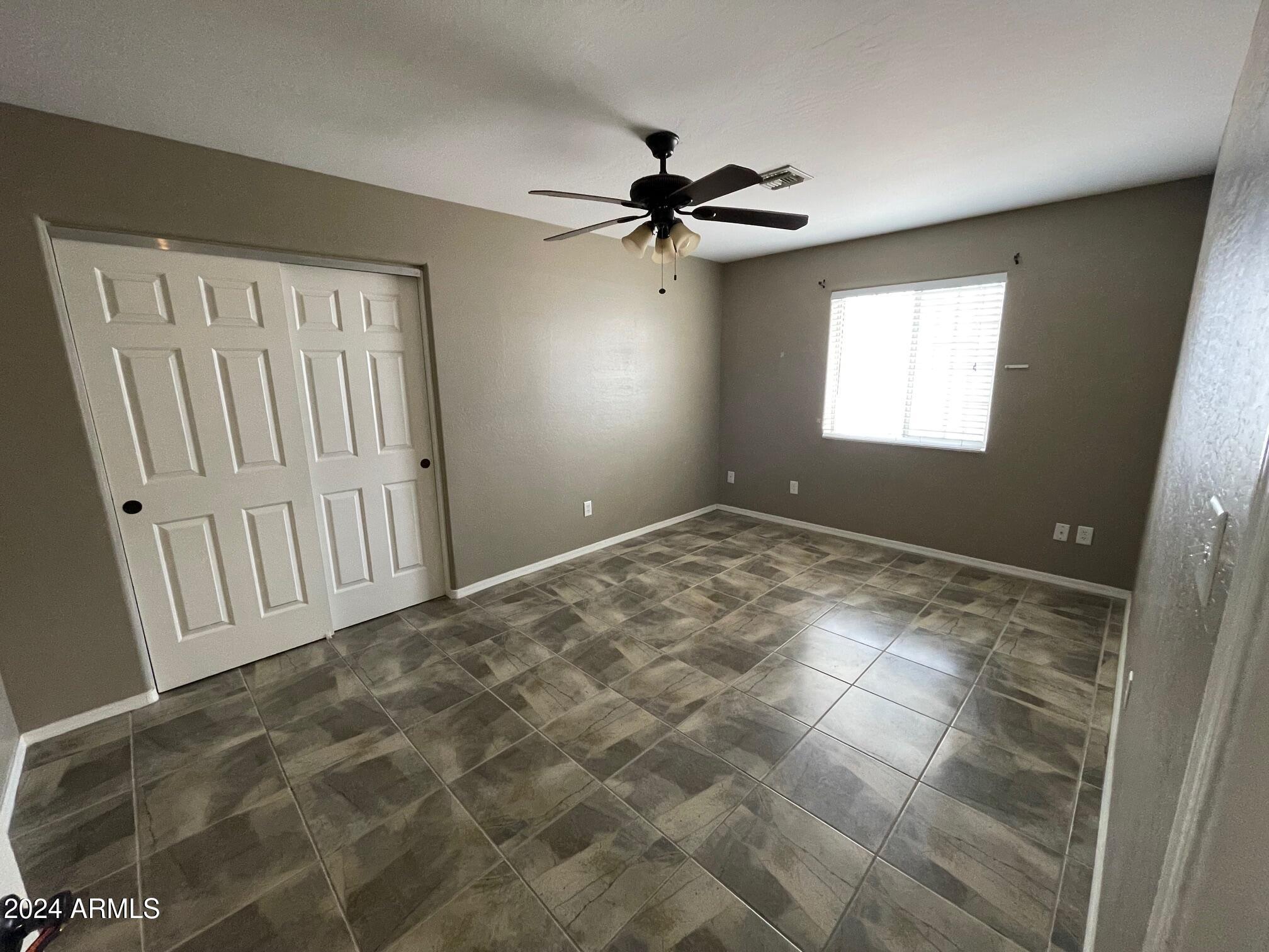 115 West 10th Street Casa Grande, AZ 85122 - Photo 10 of 14 a view of a livingroom with a ceiling fan and window