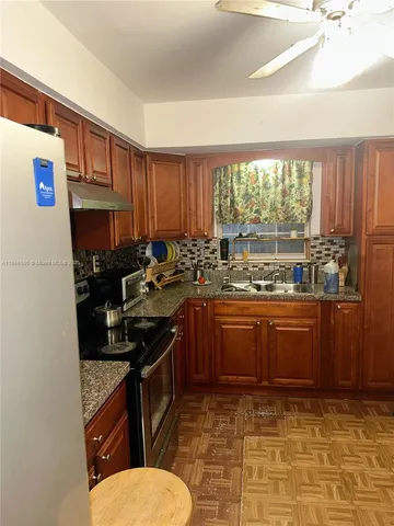 a kitchen with a sink stove and cabinets