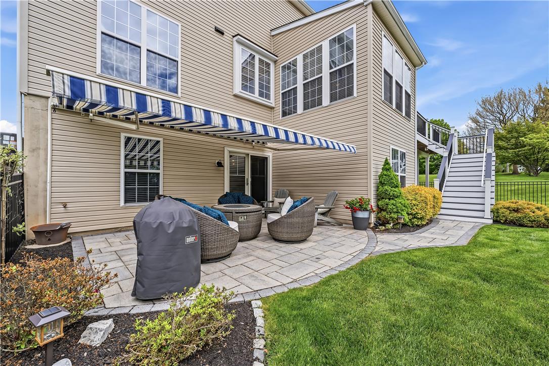 9031 Pathfinder Road Breinigsville, PA 18031 - Photo 55 of 63 An inviting stone patio beneath an awning provides the perfect outdoor entertaining space.