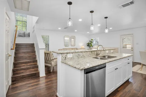 a kitchen with kitchen island a sink and a refrigerator
