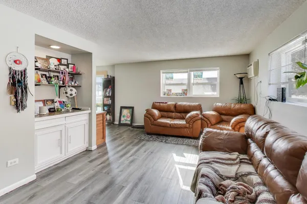 a living room with furniture and a wooden floor