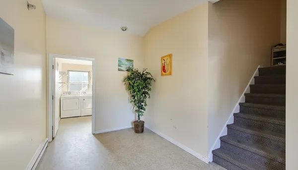 a view of an entryway with wooden floor