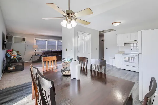 a view of a dining room with furniture and wooden floor
