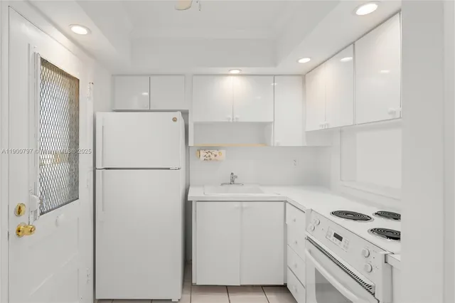 a white refrigerator freezer sitting inside of a kitchen