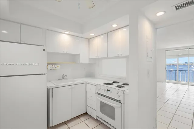 a kitchen with cabinets appliances and a sink