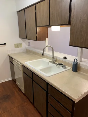a kitchen with granite countertop a stove and a microwave