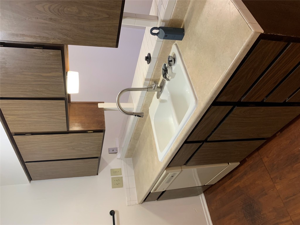 8112 Sonnet Avenue, Unit 102 Austin, TX 78759 - Photo 4 of 11 a kitchen with a sink and a cabinets