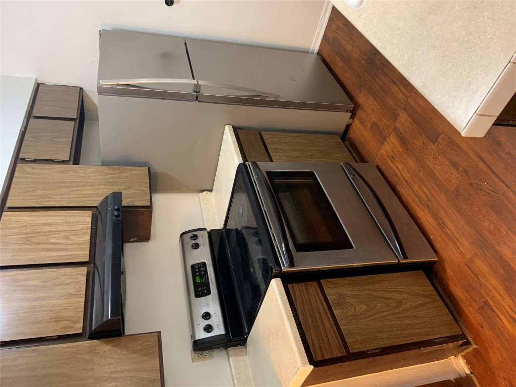 8112 Sonnet Avenue, Unit 102 Austin, TX 78759 - Photo 5 of 11 a kitchen with granite countertop a stove and a microwave