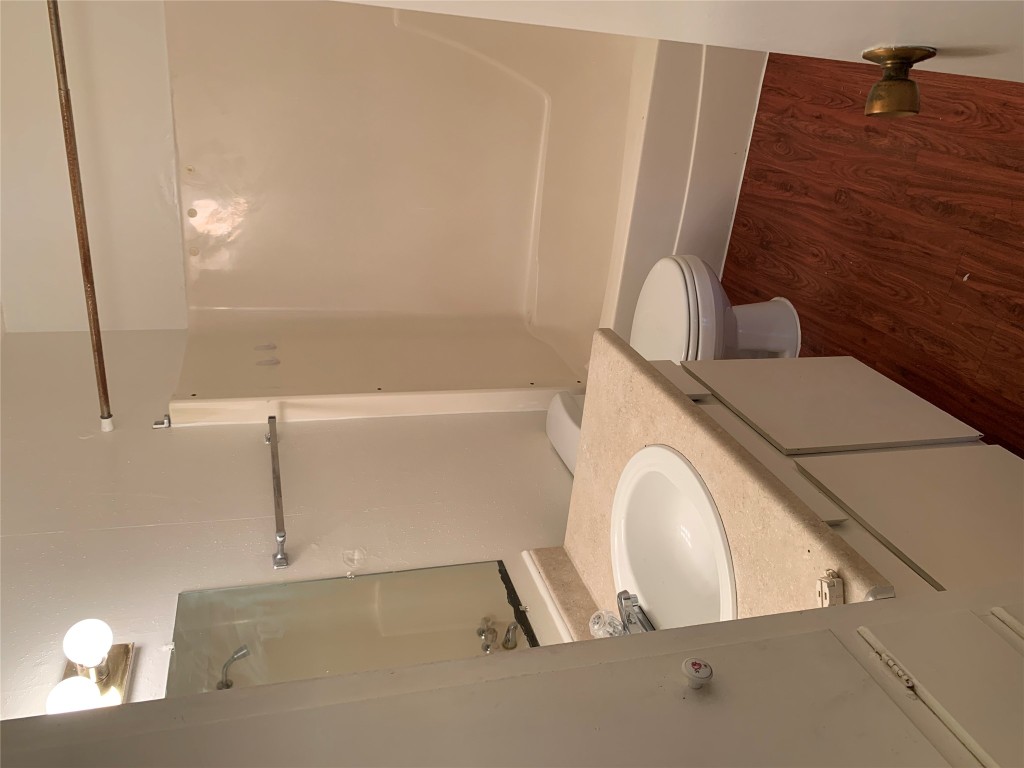 8112 Sonnet Avenue, Unit 102 Austin, TX 78759 - Photo 9 of 11 a bathroom with a sink a toilet and shower