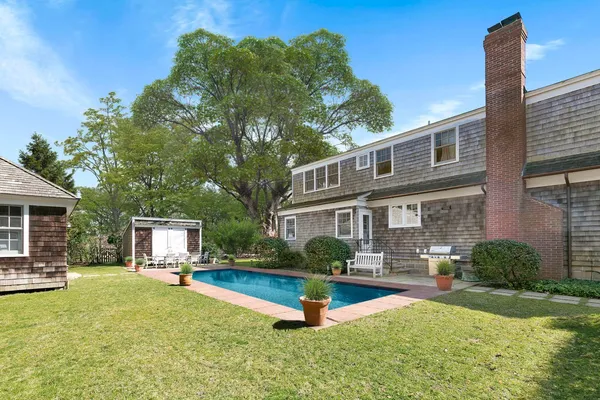 a front view of house with yard and outdoor seating