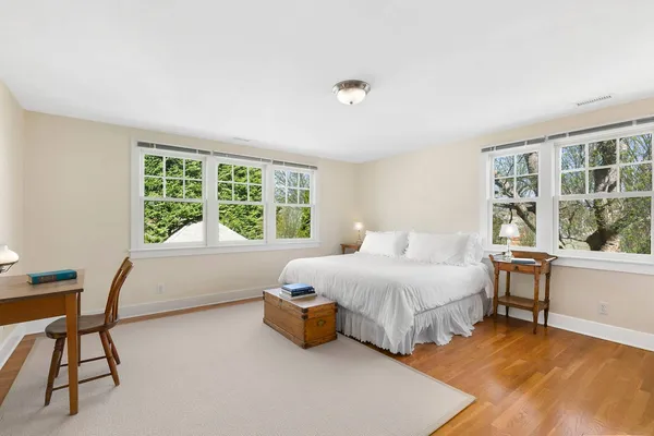 a bedroom with a bed and a large window