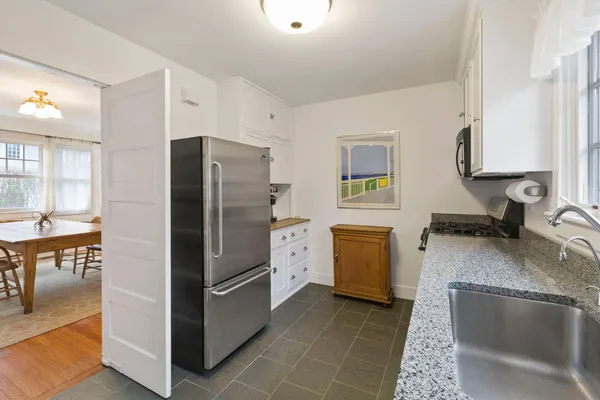 a kitchen with a refrigerator stove and sink