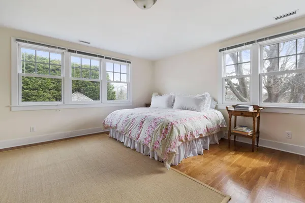a spacious bedroom with a bed and a large window
