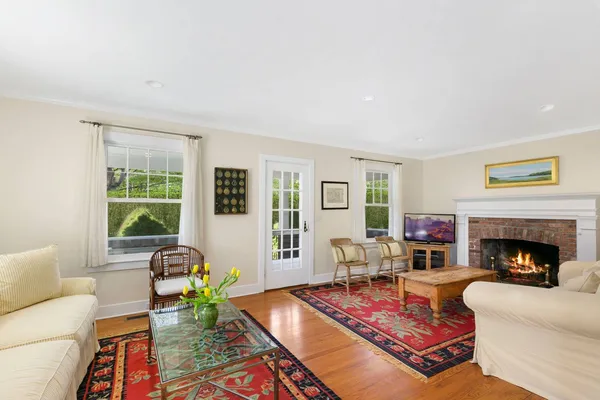 a living room with furniture fireplace and window