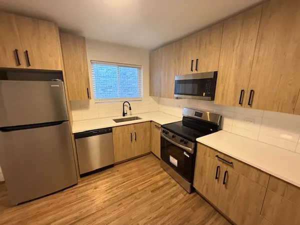 a kitchen with a refrigerator stove and microwave