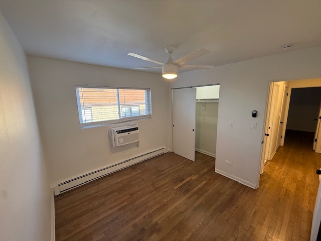 7357 North Winchester Avenue, Unit 2M Chicago, IL 60626 - Photo 7 of 12 an empty room with wooden floor and windows