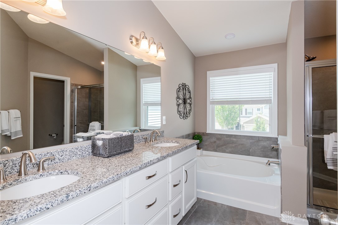 146 Rippling Brook Lane Springboro, OH 45066 - Photo 19 of 42 Granite countertops, raised vanities, 8" spread faucet, ceramic shower wall tile 12" x 24", and ceramic tile floor.
