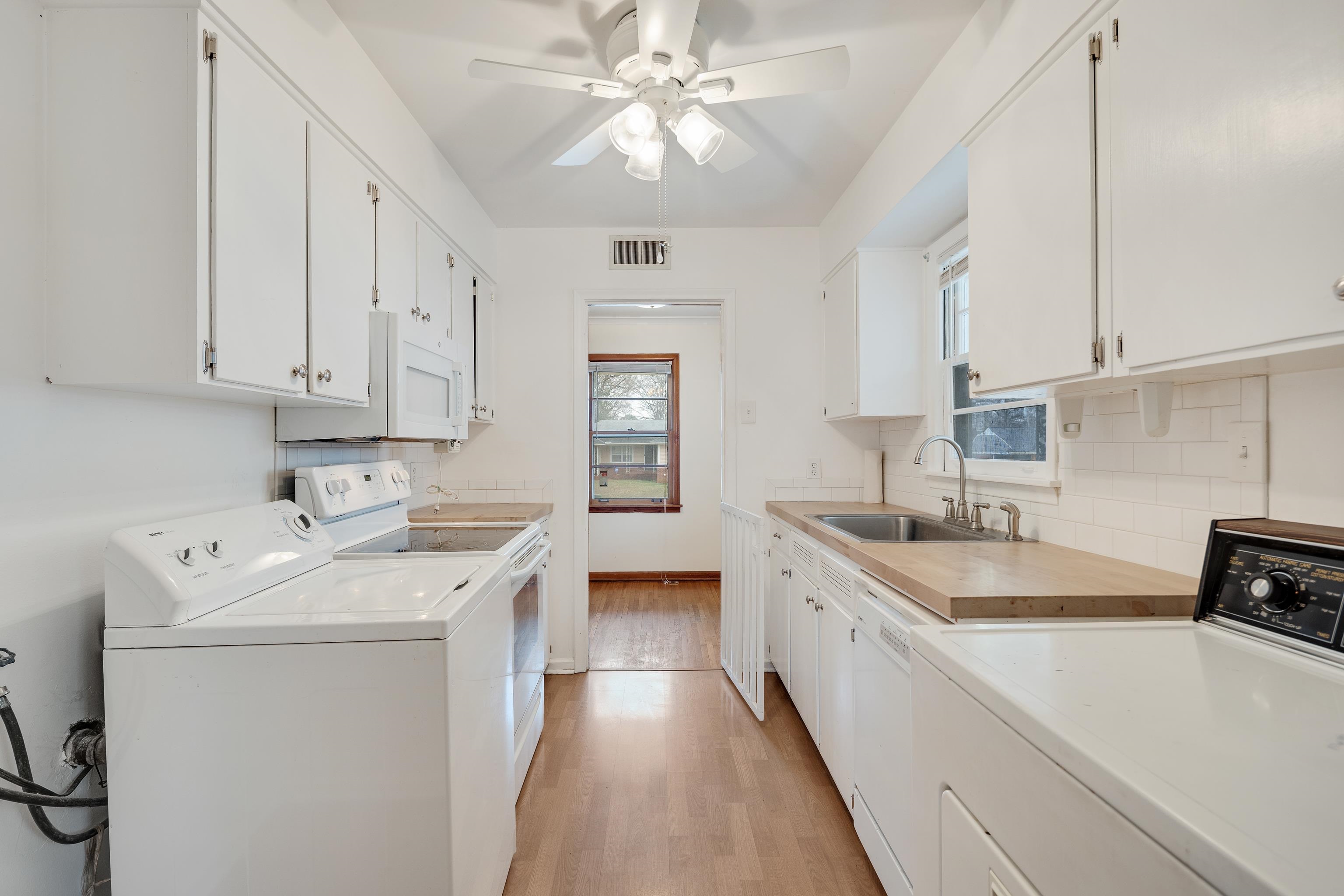 4928 Flamingo Road Memphis, TN 38117 - Photo 11 of 30 a kitchen with a sink a stove and cabinets