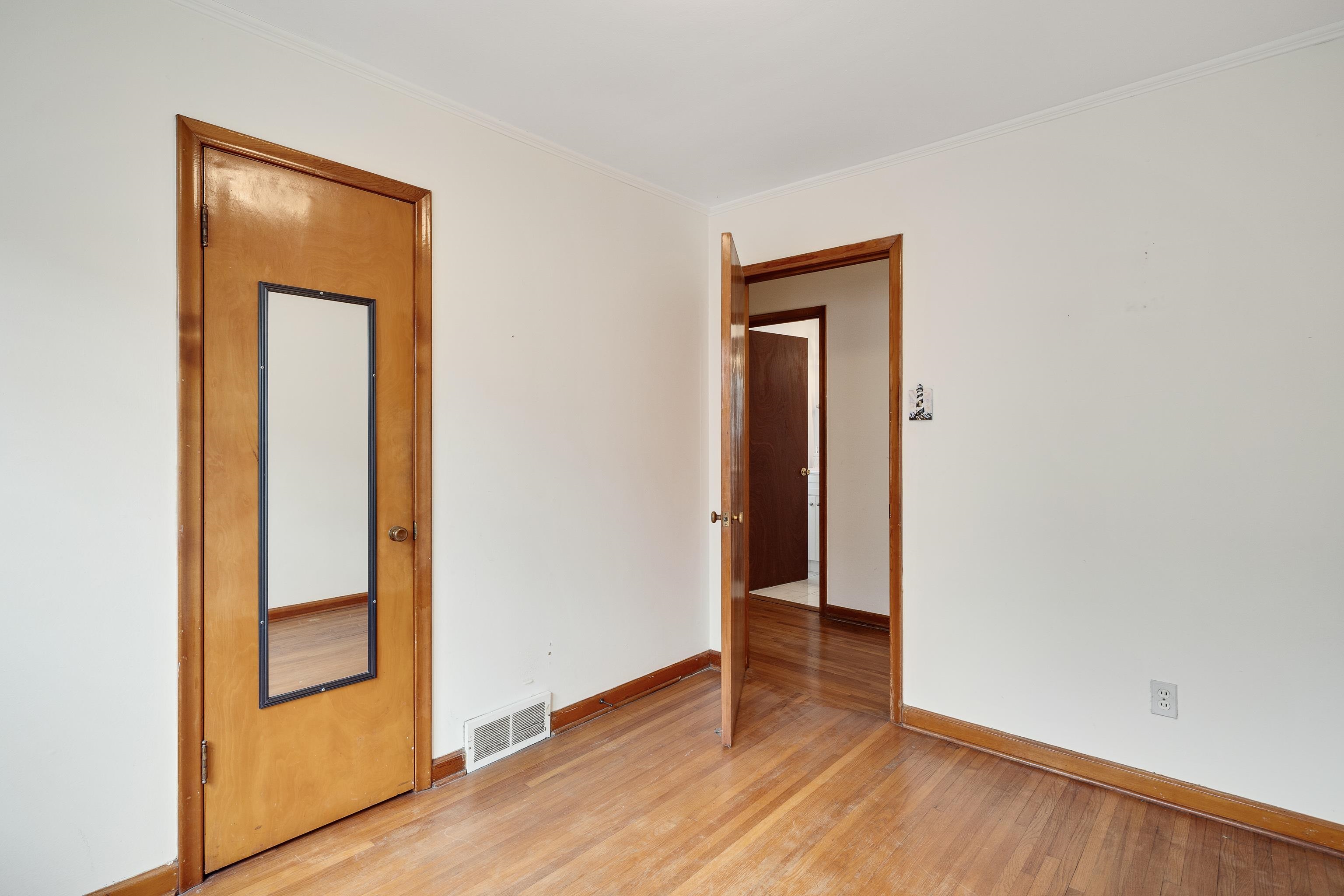 4928 Flamingo Road Memphis, TN 38117 - Photo 18 of 30 a view of an empty room with wooden floor and closet