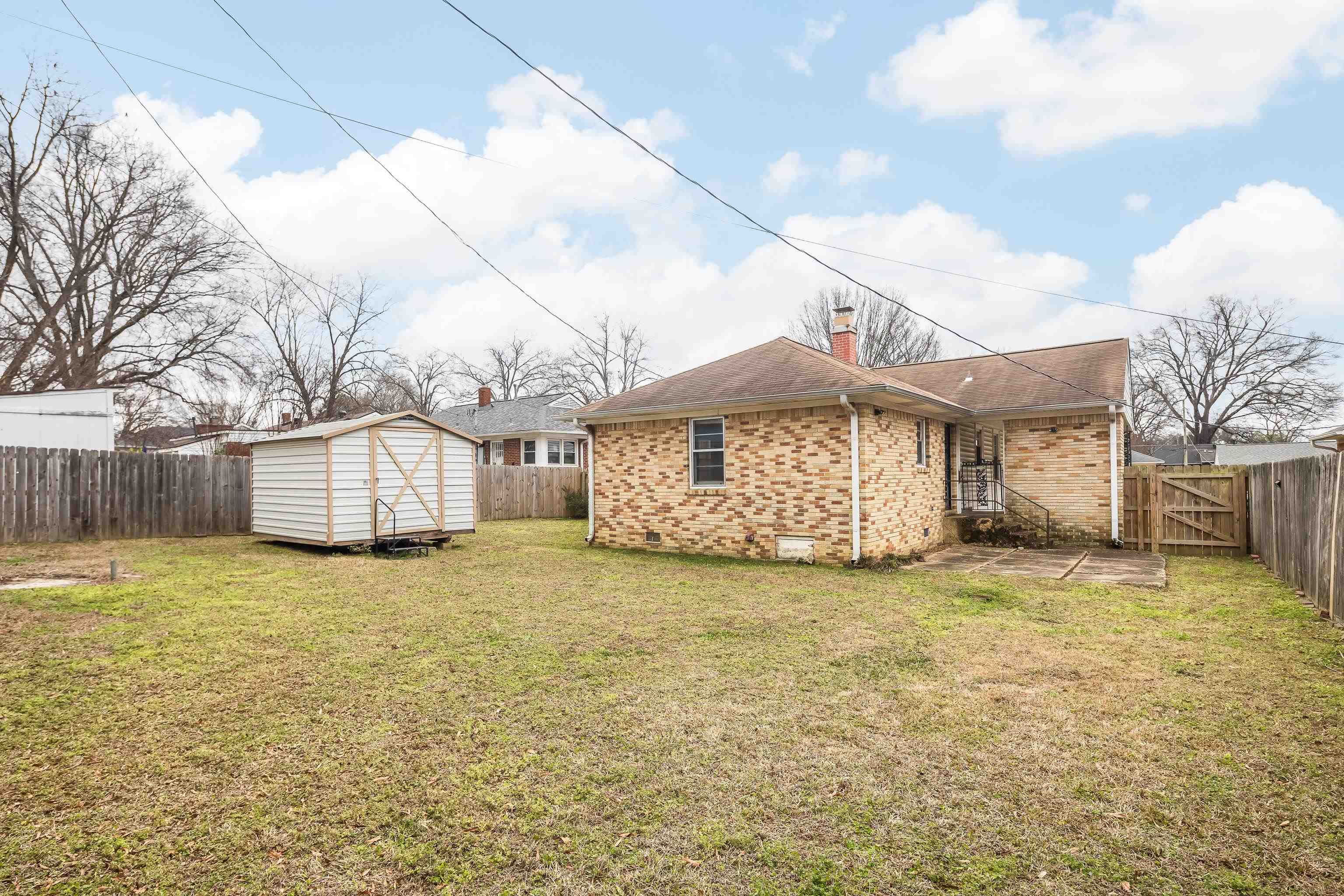 4928 Flamingo Road Memphis, TN 38117 - Photo 26 of 30 a view of a house with a yard and garage