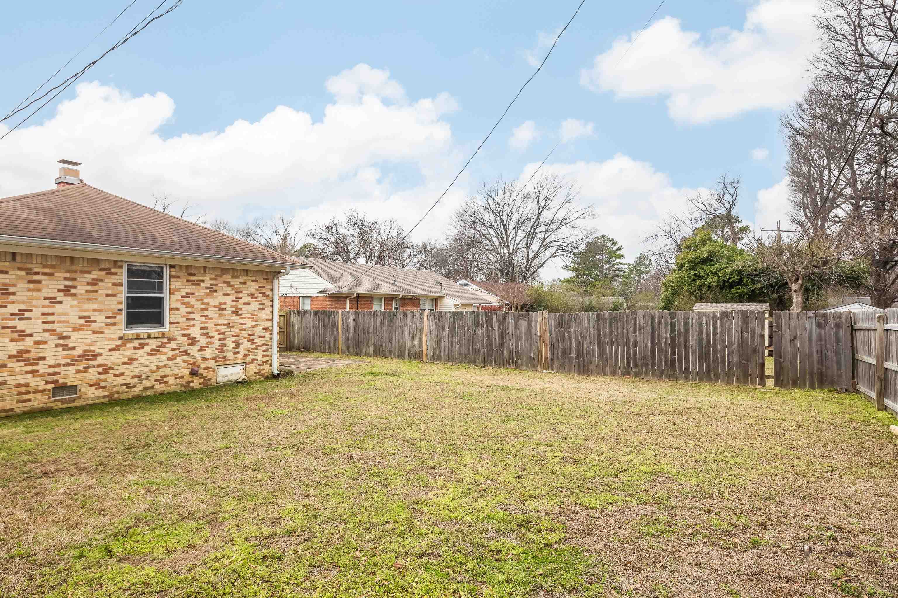 4928 Flamingo Road Memphis, TN 38117 - Photo 28 of 30 a view of a house with a yard and wooden fence