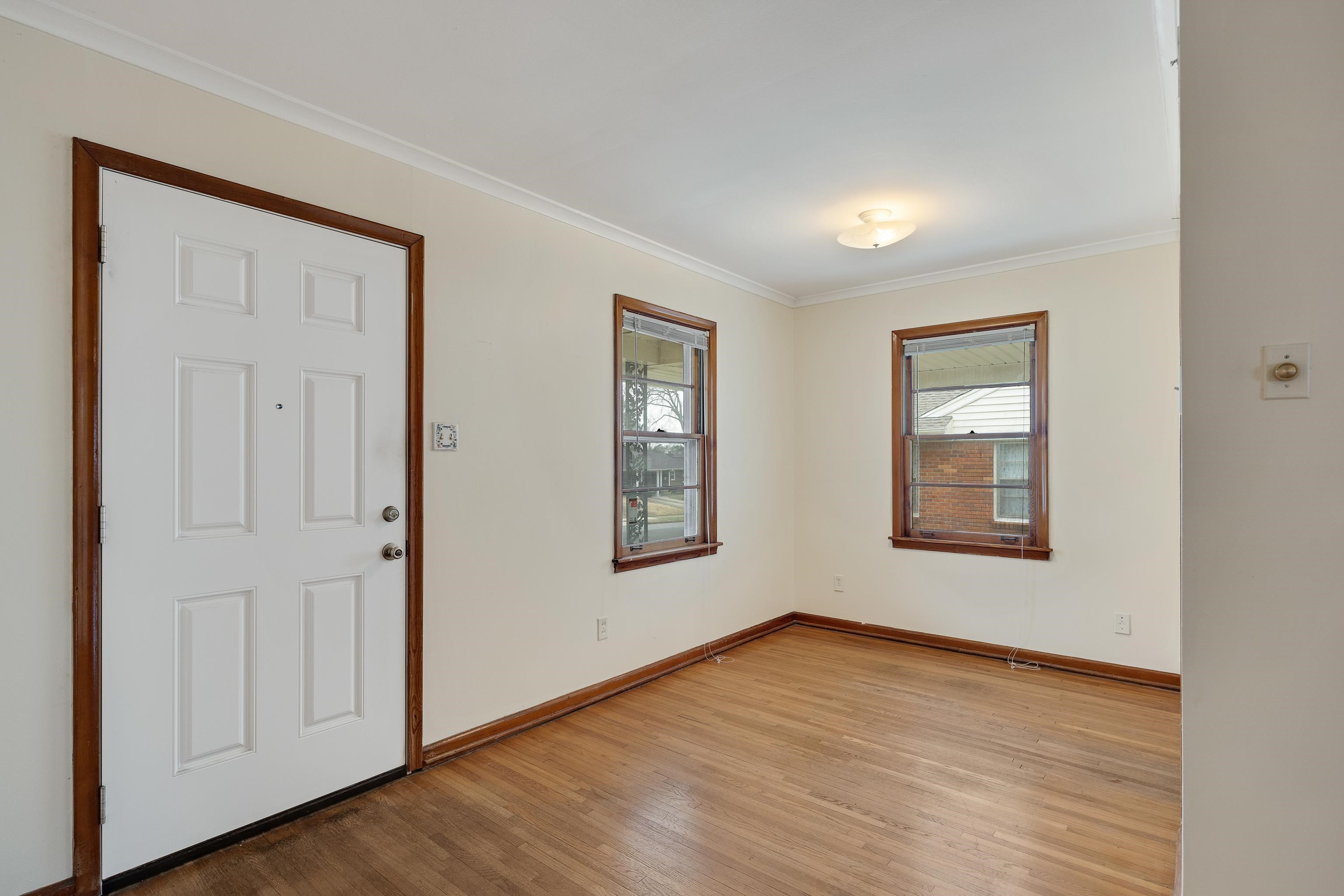 4928 Flamingo Road Memphis, TN 38117 - Photo 3 of 30 an empty room with wooden floor and windows