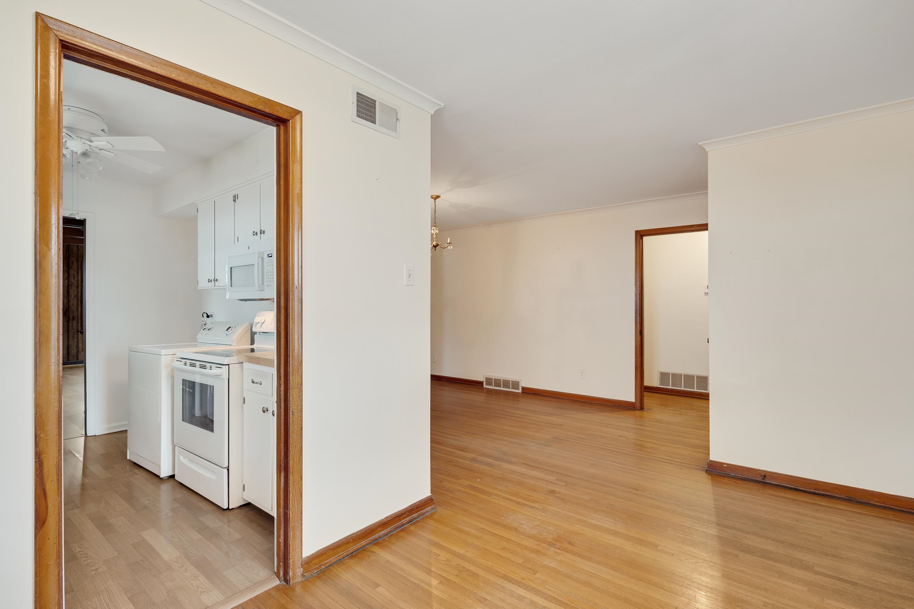 4928 Flamingo Road Memphis, TN 38117 - Photo 4 of 30 a view of a hallway with wooden floor and a bathroom