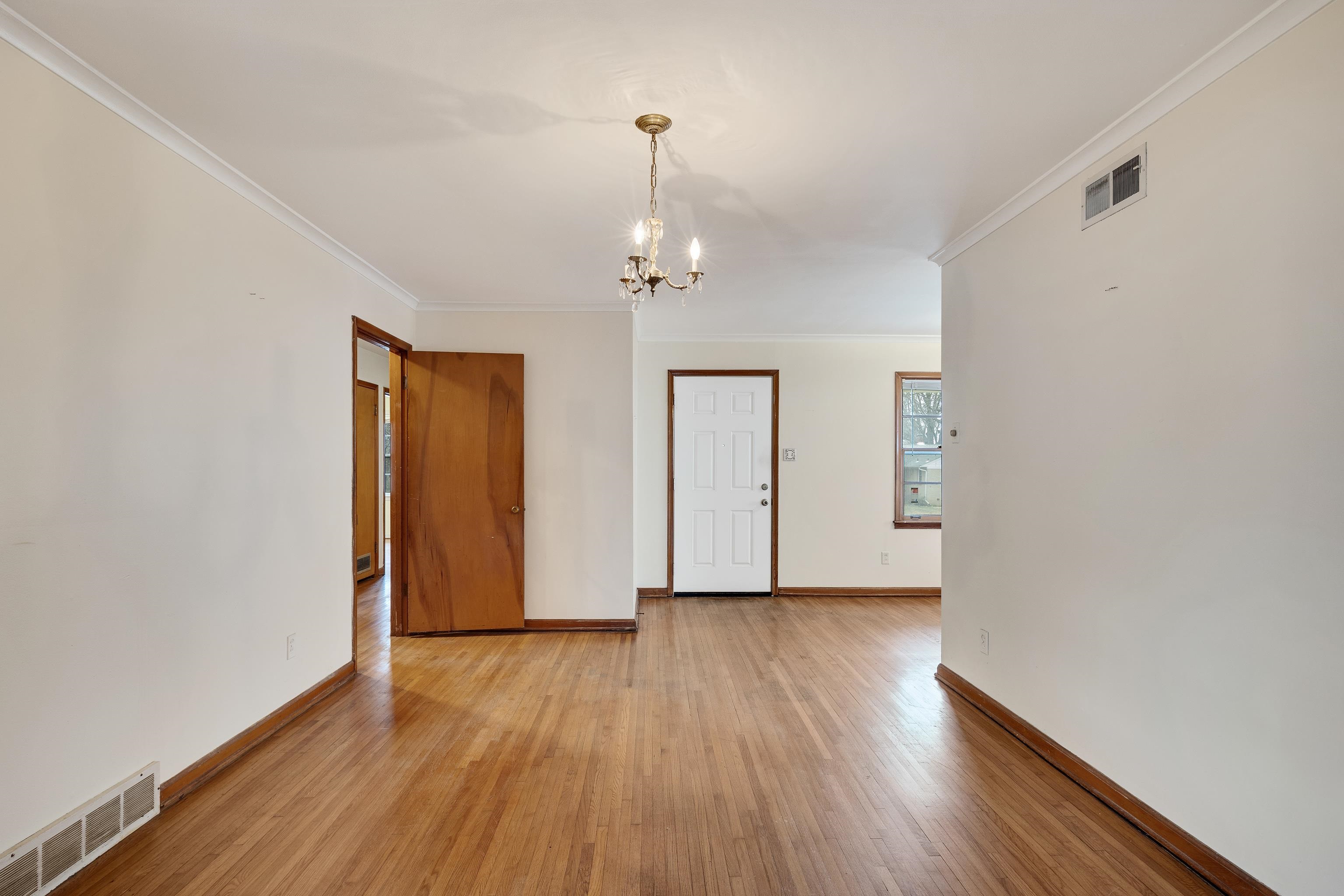 4928 Flamingo Road Memphis, TN 38117 - Photo 6 of 30 an empty room with wooden floor and windows