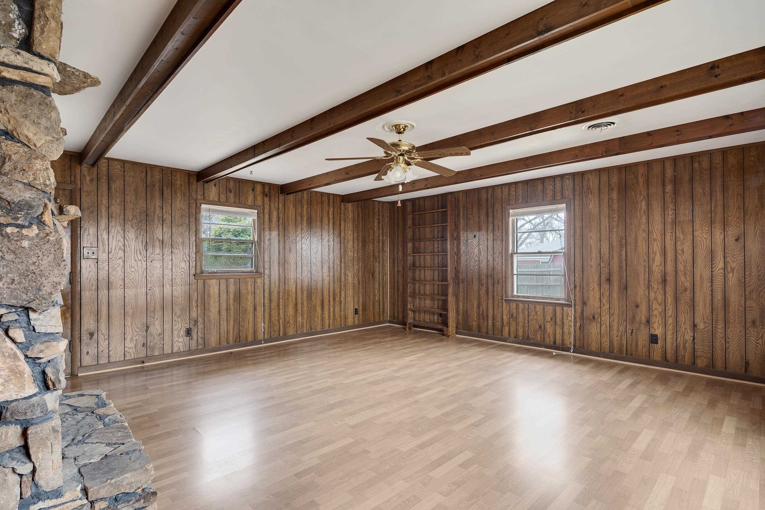 4928 Flamingo Road Memphis, TN 38117 - Photo 7 of 30 a view of an empty room with wooden floor and a window