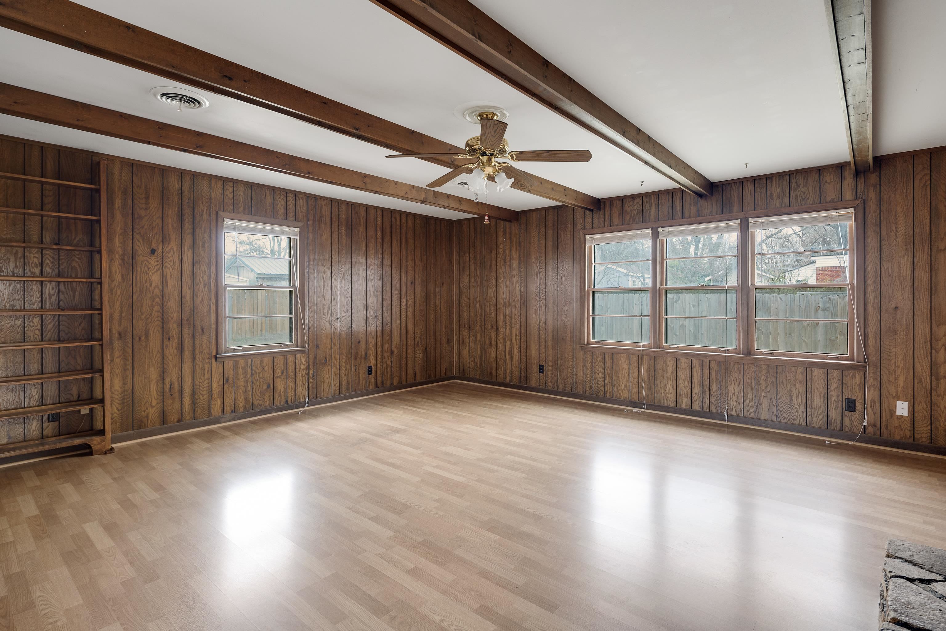 4928 Flamingo Road Memphis, TN 38117 - Photo 10 of 30 a view of an empty room with wooden floor and a window