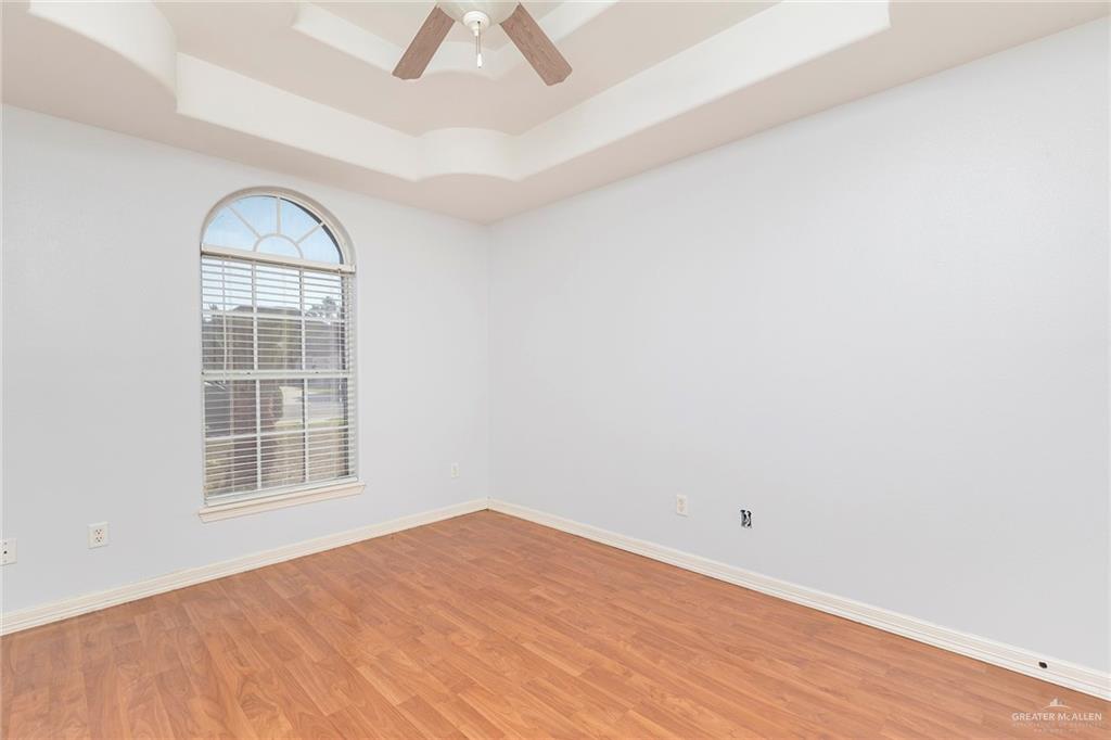 1909 Ezekiel Street Edinburg, TX 78542 - Photo 11 of 16 an empty room with wooden floor cabinet and windows