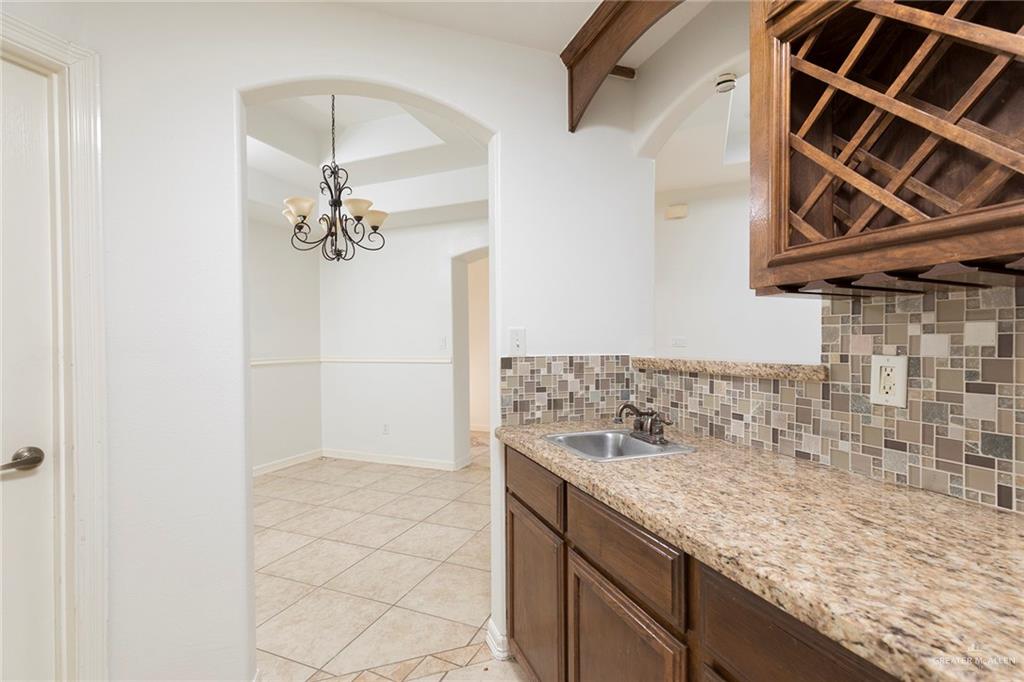 1909 Ezekiel Street Edinburg, TX 78542 - Photo 5 of 16 a bathroom with a granite countertop sink a mirror and shower