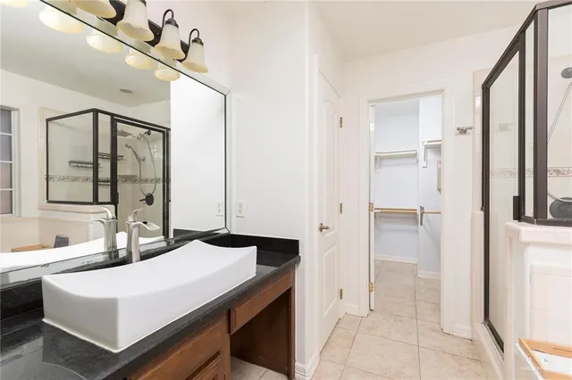 an empty room with wooden floor cabinet and windows